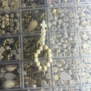 This is a bracelet with a cross and cream colored beads